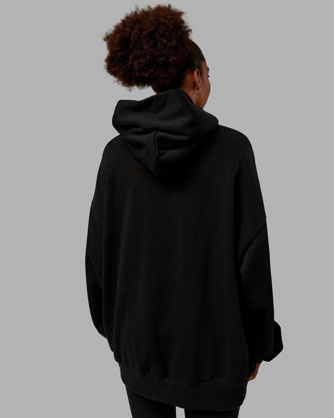 Woman wearing Unisex MVP Hoodie Oversize - Black