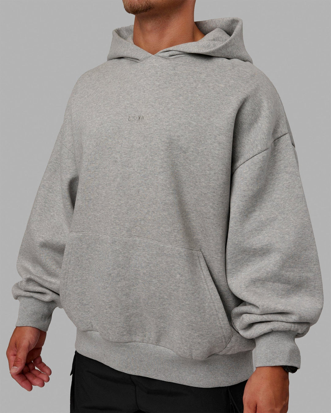 Man wearing Unisex MVP Hoodie Oversize - Lt Grey Marl